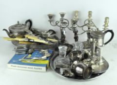 A collection of silver plated wares, including candelabra,