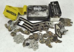 A collection of WWI and other military cap badges,