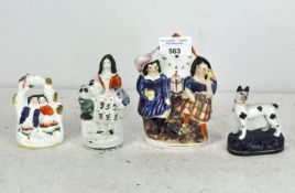 A group of Staffordshire figures, including a dog,