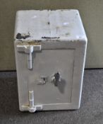 A white painted small safe, with key,
