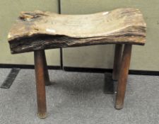 A naturalistic oak stool, raised on four splayed feet,