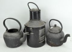 Two cast iron kettles together with a lamp