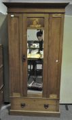 An oak single wardrobe, circa 1900, with fitted mirror door, inlaid with figural marquetry,