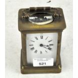 A 20th century brass cased carriage clock, the enamel dial with Roman numerals denoting hours,