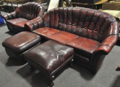 A three seater and a two seater sofa and two footstools, 20th century,