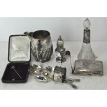 A collection of silver items, including a scent bottle, cigarette case, sugar tongs,