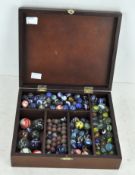 A collection of vintage marbles, in hinged wooden box,
