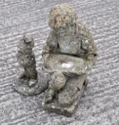 A reconstituted stone garden gnome, together with a kneeling figural support and a tree stump base,