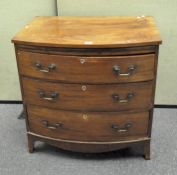 A mahogany bow fronted chest of drawers, comprising three long drawers,
