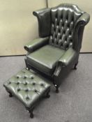 A dark green wingback armchair with button back, approximately 105cm high,