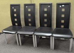 A set of four modern dining chairs,