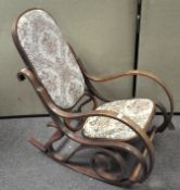 A vintage bent wood rocking chair, with upholstered seat,