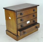 A four drawer tabletop collectors chest of drawers,