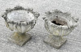 Two reconstituted stone urns, of flared acanthus form,