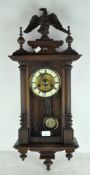 A 20th century carved wall clock, with eagle finial to top,