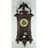 A 20th century carved wall clock, with eagle finial to top,