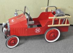 A vintage child's pedal car fire engine by Baghera