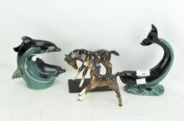 Two Poole pottery figures of dolphins,
