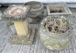 Three reconstituted stone garden planters and a footed bird bath,