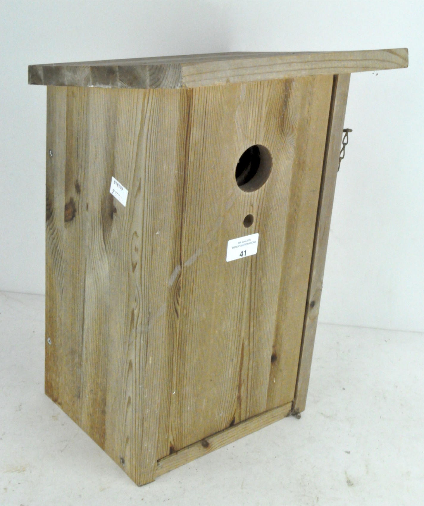 A novelty wine glass holder in the form of a bird house