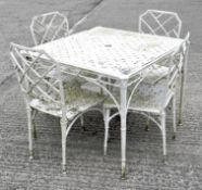A white painted metal garden table with four chairs, simulated wicker design, chairs 85cm high,
