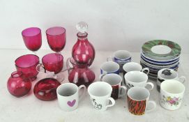 A collection of assorted tea and coffee cups, each with transfer printed decoration,