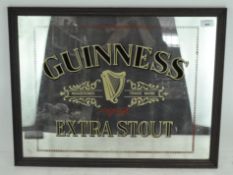 A Guinness extra stout advertising wall mirror, in wooden frame,
