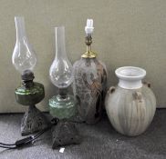 Two oil lamps with green glass reservoirs; an Egyptian style stoneware lamp base and a vase,
