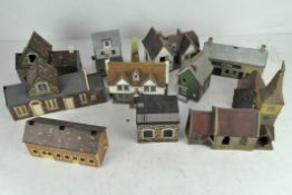 A quantity of Britains and Hornby scenery pieces, including station buildings, Churches and shops,