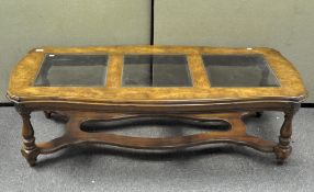 A large modern veneered coffee table, the top with three bevelled edge glass inserts,
