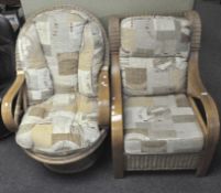 Two modern rattan and upholstered conservatory style armchairs, the larger with rotational base,