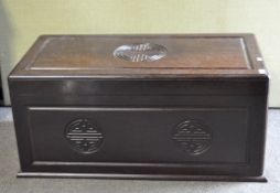 A Chinese hardwood coffer with hinged cover, with carved seal ornament, 103.