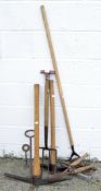 A selection of assorted tools, including a pickaxe, a fork, a hoe,