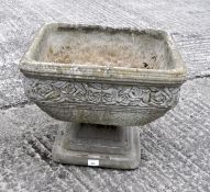 A garden square section footed planter, cast with roses,