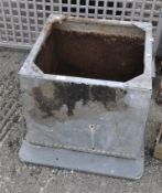 A square section galvanized metal planter with riveted ornaments,