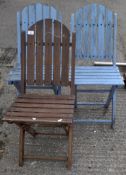 Three wooden slatted folding garden chairs, two painted in blue,