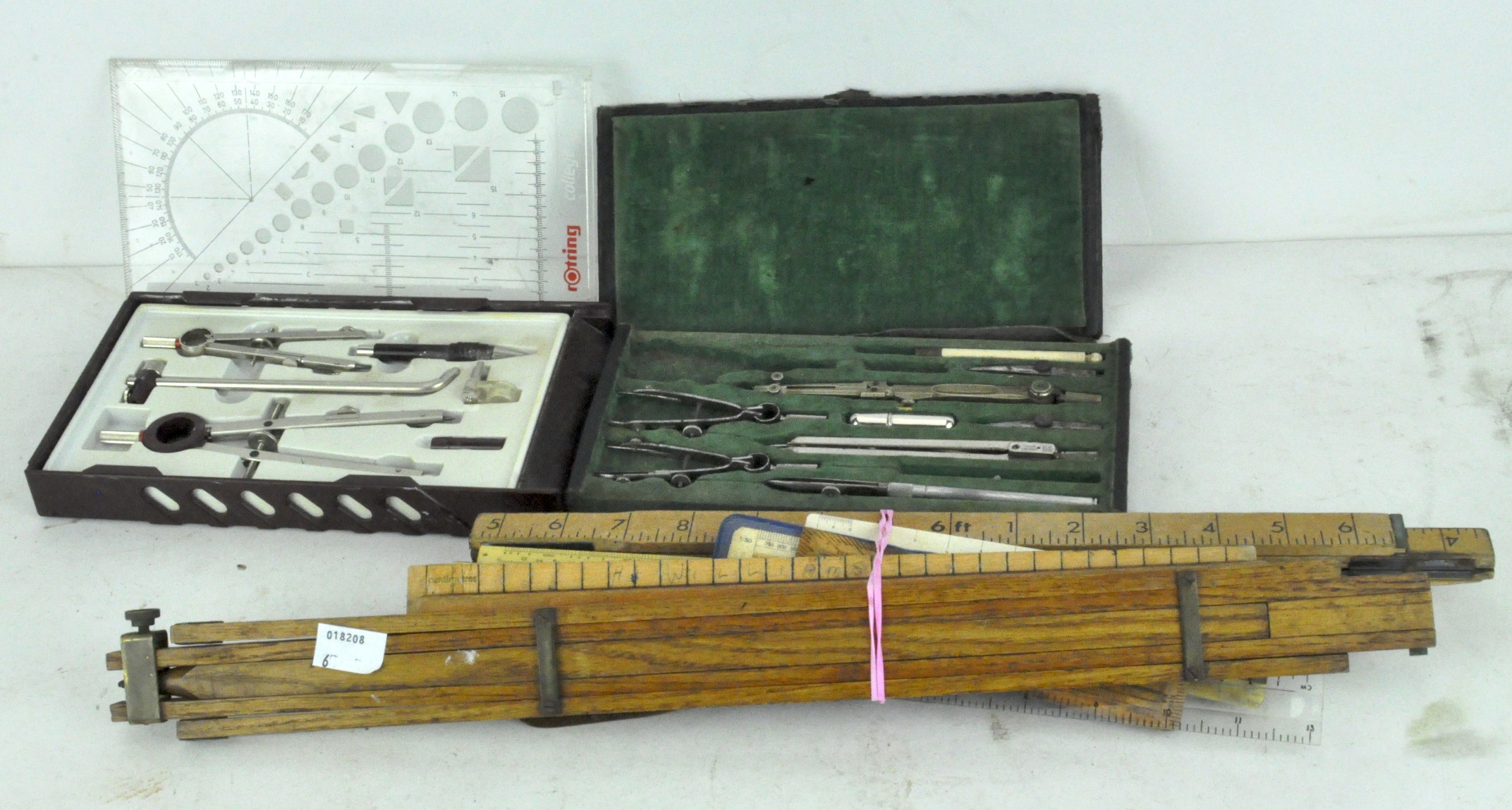 A collection of drawing equipment, slide rules and vintage rulers,