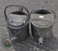 Two galvanized watering cans, one marked Apex,