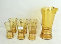 A vintage glass lemonade set, golden in colour with gilt banding,