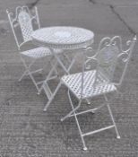 A white painted aluminum garden table and two chairs, with pierced decoration, chairs 94cm high,