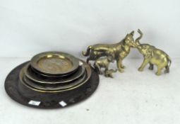 A selection of brass ware, trays, two models of elephants, a hound and other items,