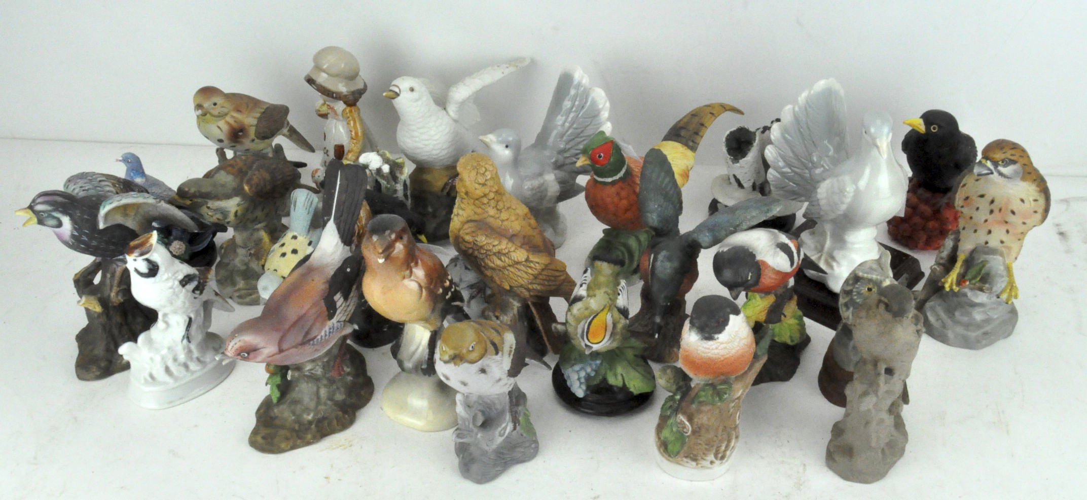 A large collection of ceramic figures of birds,
