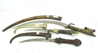 Three Moroccan knives, one with inlaid brass detailing,