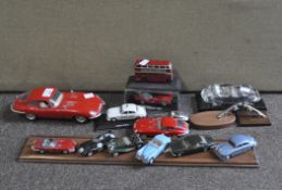 A collection of die cast vehicles, including Jaguar, Ferrari, 2013, two Jaguar car mascots mounted,