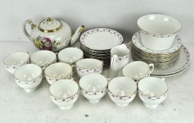 An extensive porcelain tea set, floral border on a white ground,