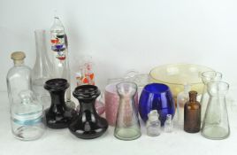 A collection of various glassware, including an empty poison bottle,