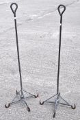 Two industrial metal abattoir hooks, each with four hooks,