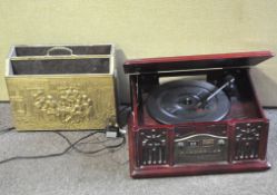 A modern Prolectrix record deck and a brass newspaper rack cast with Tenniers-type scenes,