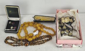 A collection of costume jewellery, including a bead necklace, cheroot holder in box,