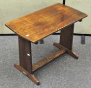 An Arts and Crafts style small table, pegged joints with carving on legs and front and back edge,